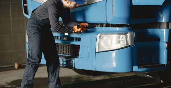young worker checks wheel truck malfunction service work min